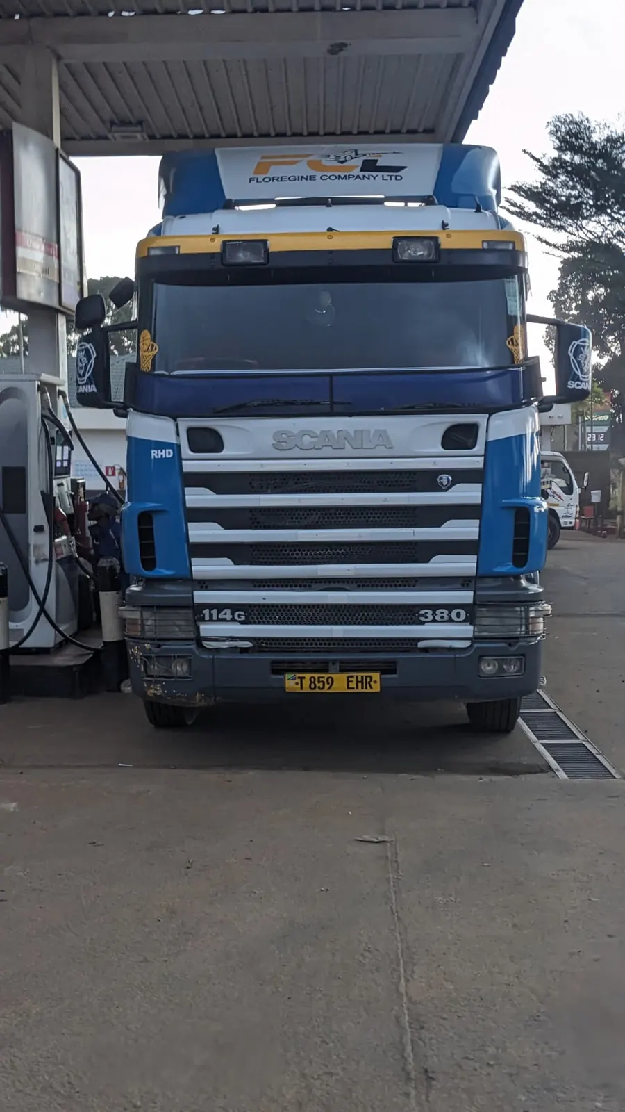 Blue and white Floregine Scania truck at a fuel station