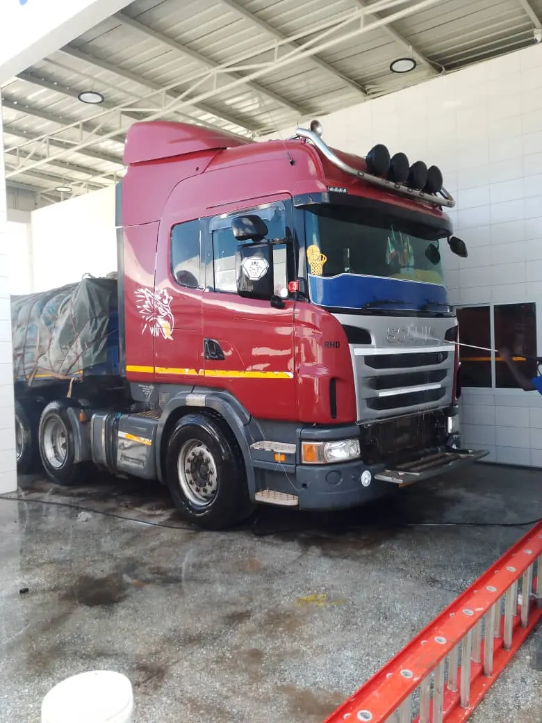Red Floregine Scania truck at an operations facility